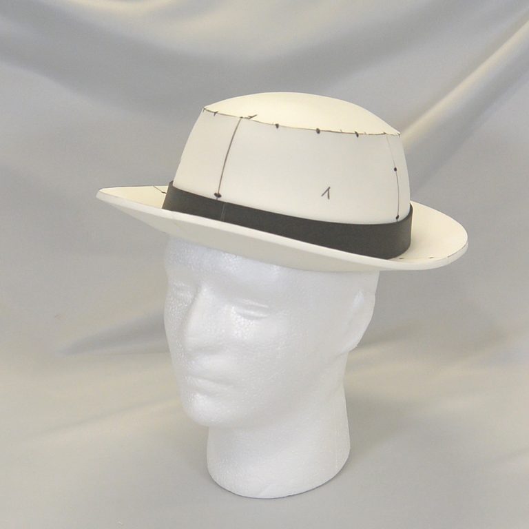 Retro hat made with white and black EVA foam, sitting on top of a Styrofoam head - cosplay item