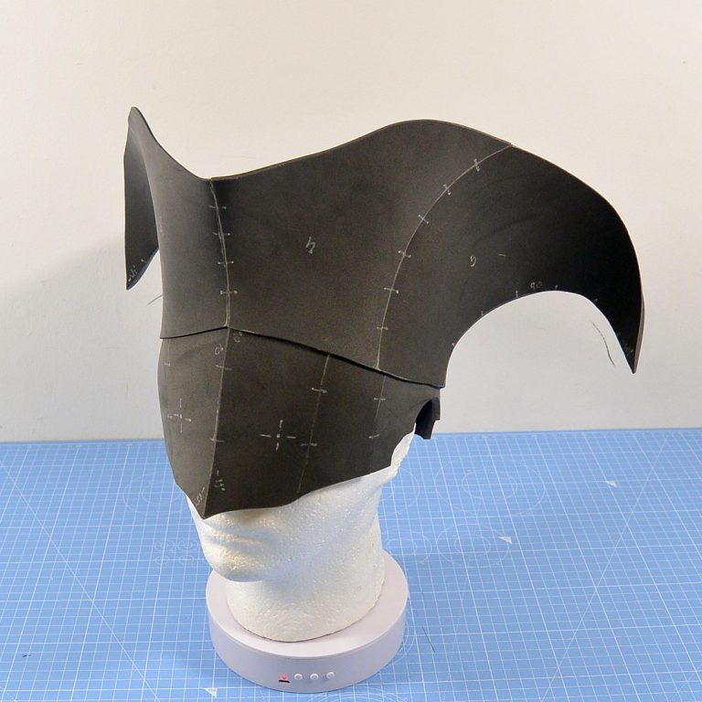 Italian canaveral inspired mask with cap made using black EVA foam, sitting on top of white Styrofoam head - cosplay headgear